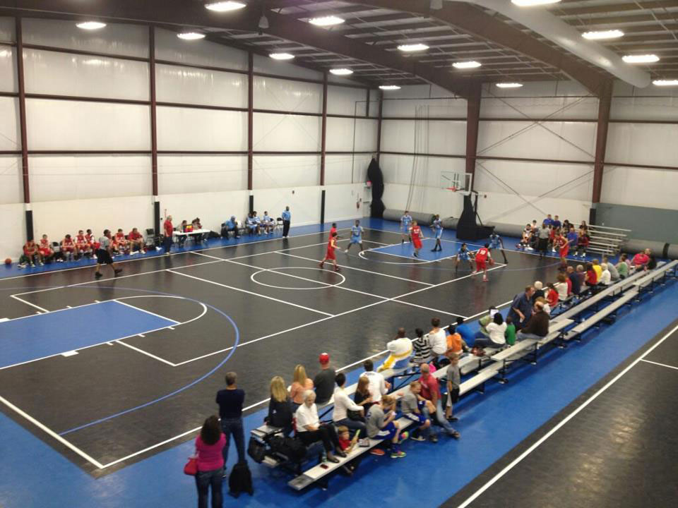 crowd watching a basketball game being played on a flexcourt court