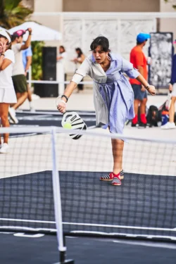 woman returning a serve in a pickleball game