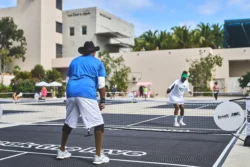 man and woman playing pickleball against each other